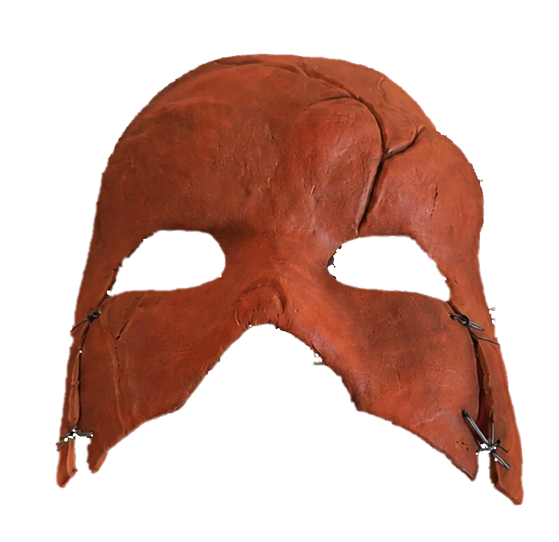 The Mortal Ascent mask: rust-red, cracked, with open eyes and barbed wire stitched at the jaw